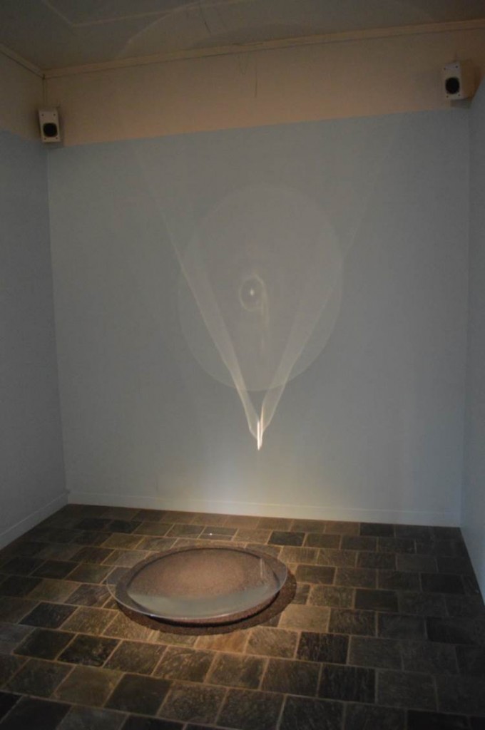 A drip above the pool sends a drop down every 10-15 seconds and light reflection casts patterns on the wall behind